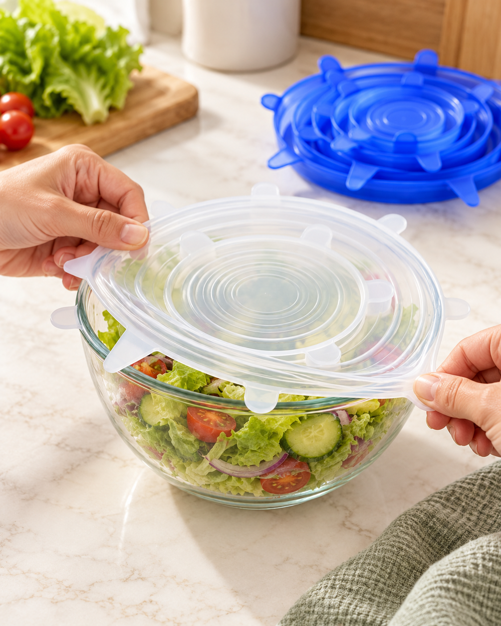 Stretching a clear reusable lid over a salad bowl